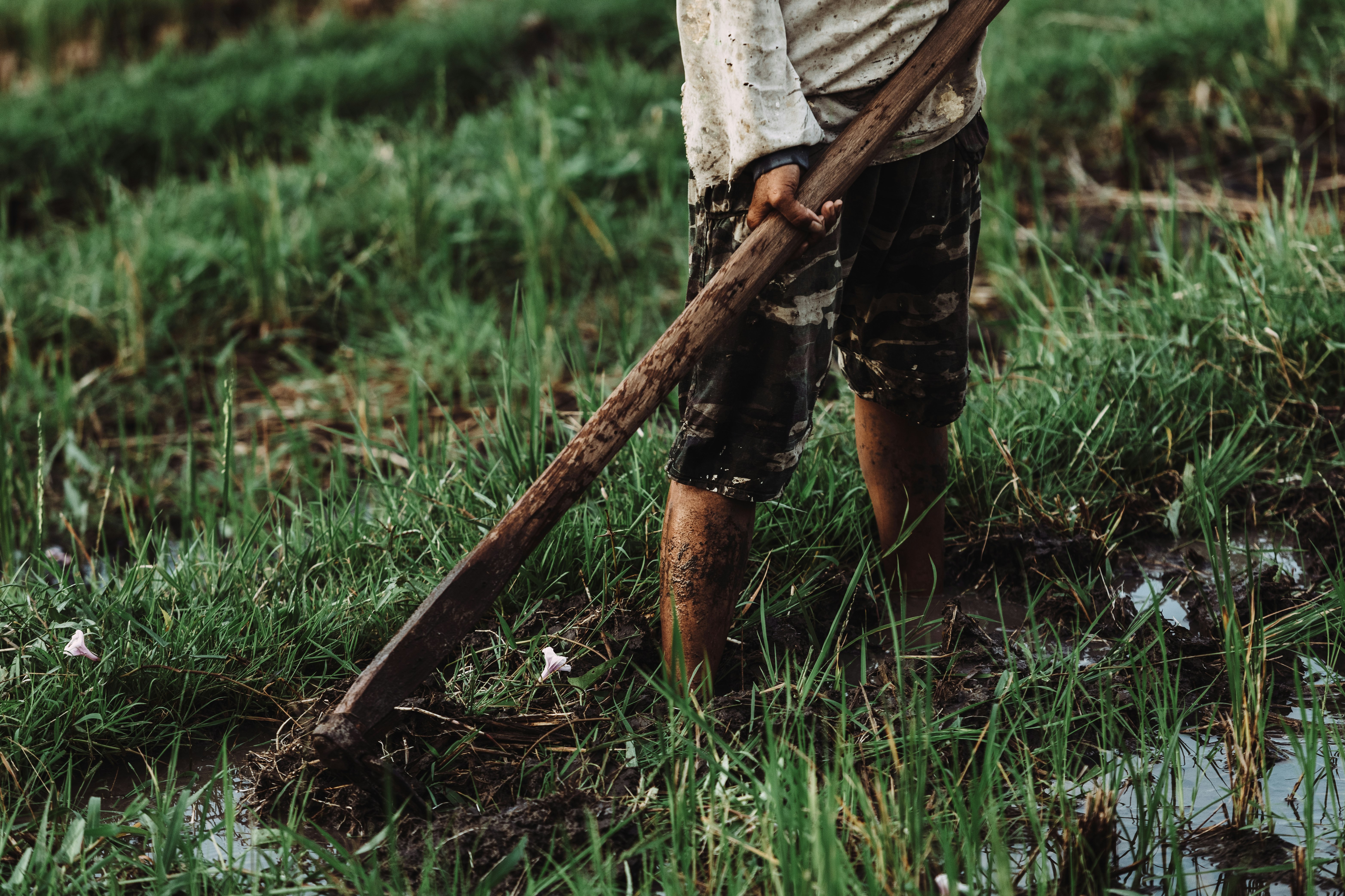 man holding brown wooden paddle